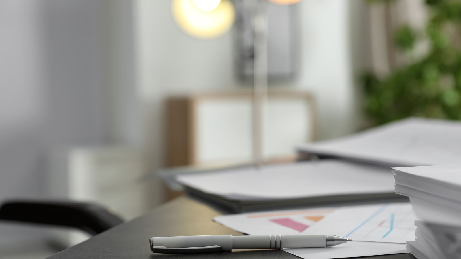 Office desk with documents and pen for analysis