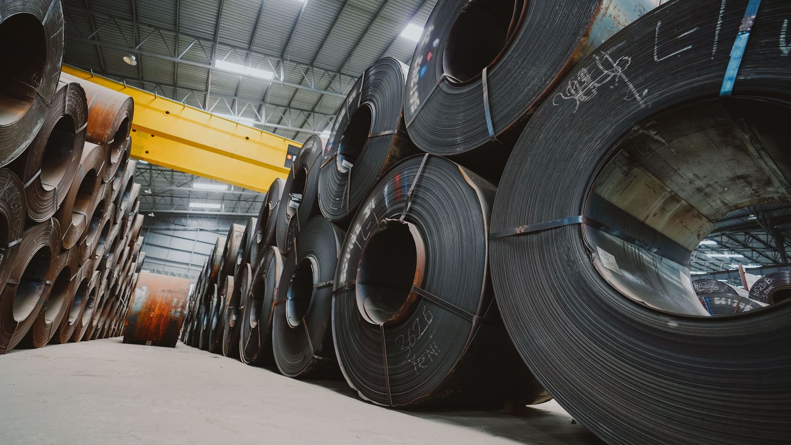 Steel coil stacks at warehouse industrial site