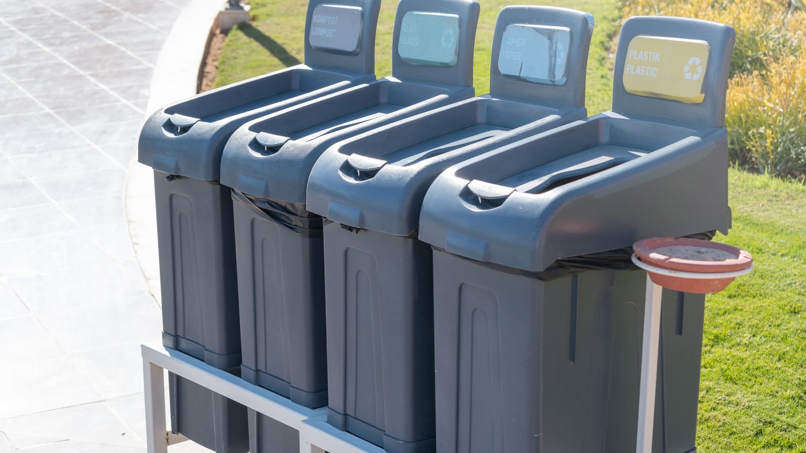 Recycling bins for compost, glass, paper, and plastic