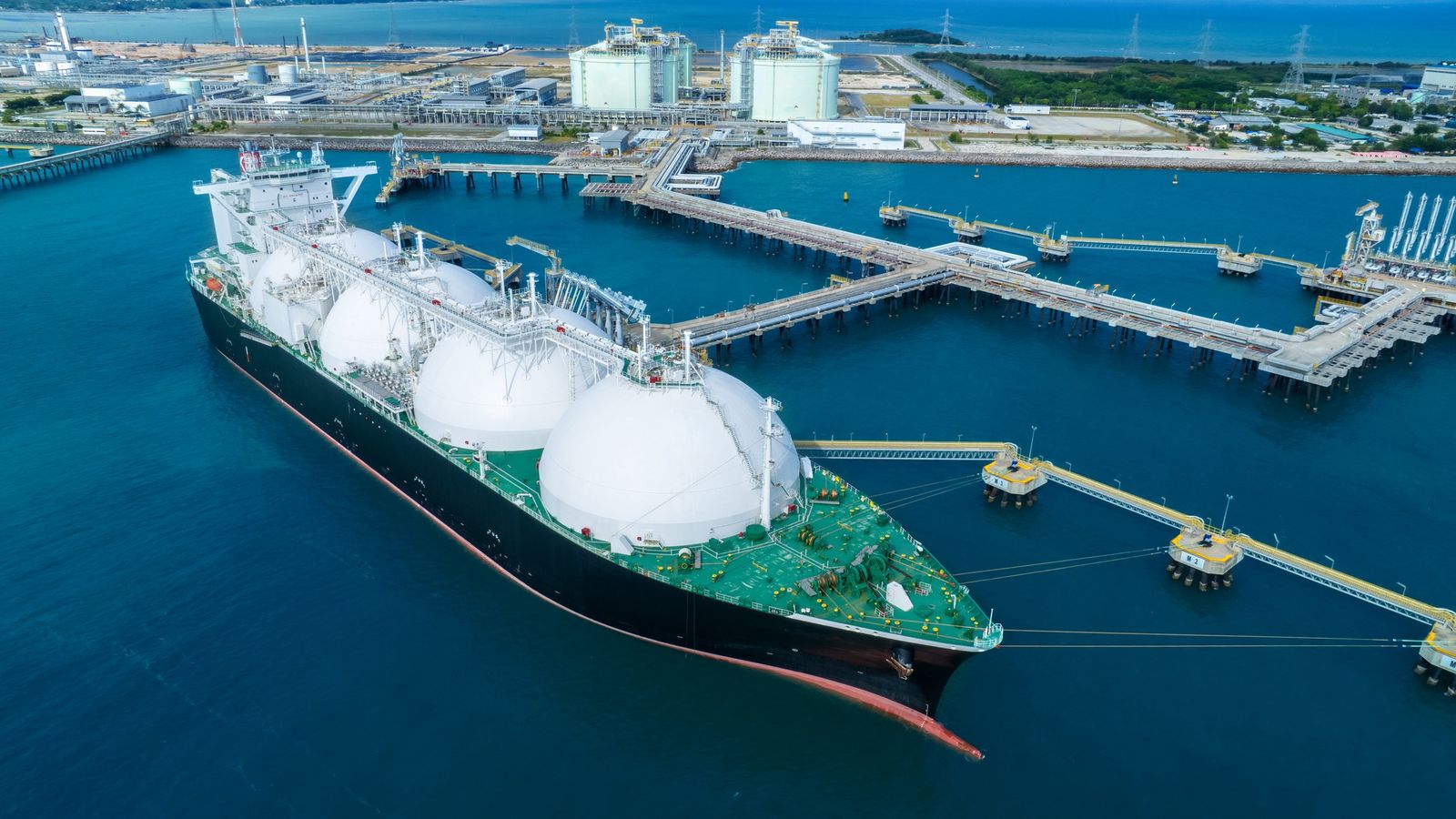 Aerial view of a liquefied gas tanker moored at a coastal terminal jetty